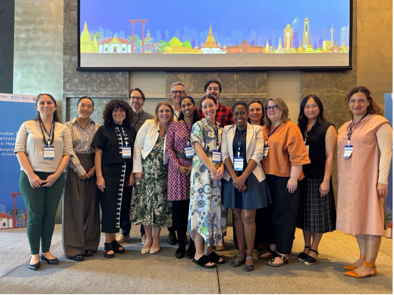 Participants at a workshop smile to pose for a group photo
