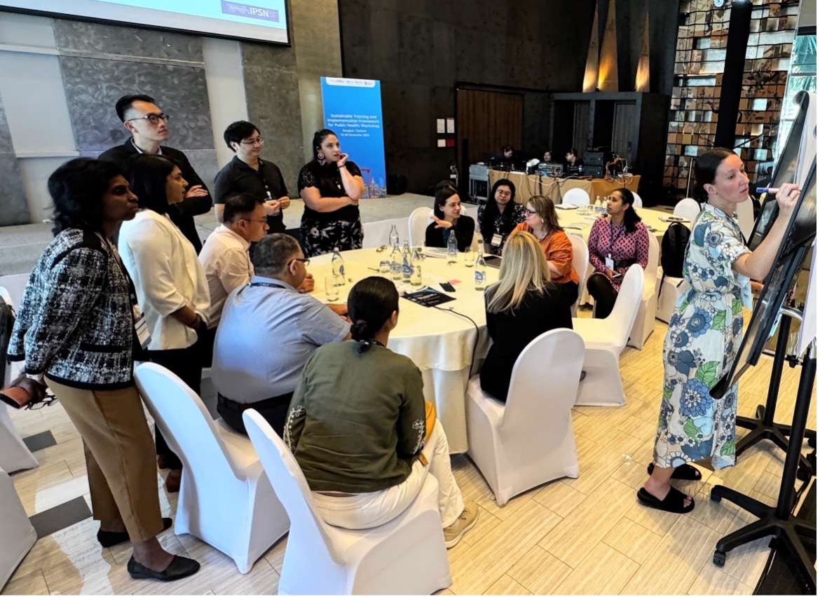 Group work at a workshop, as a participant takes notes on whiteboard